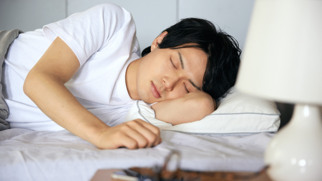 Person sleeping on their side with arm under the pillow.