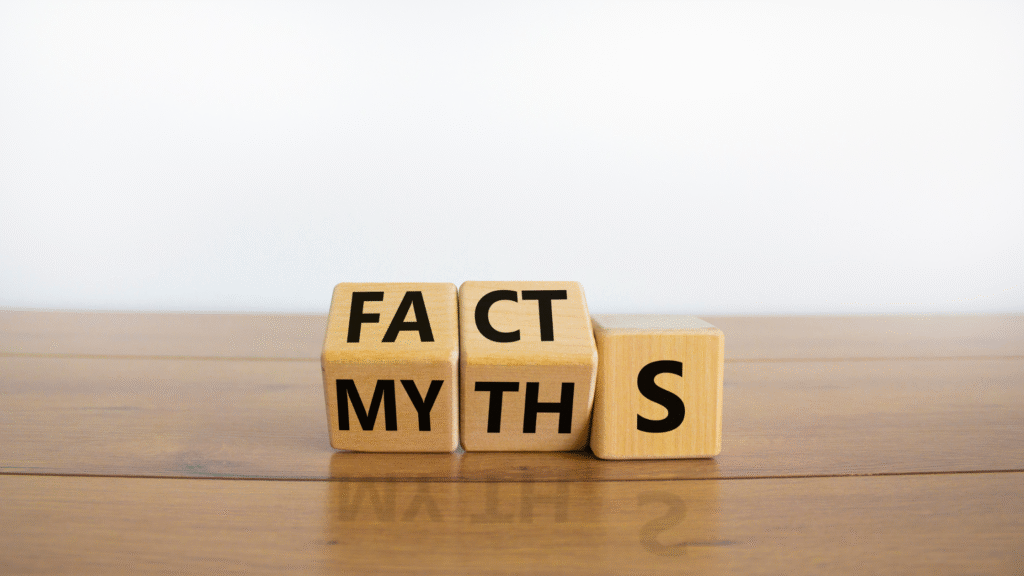Wooden blocks spelling “FACT” and “MYTHS” on a table representing misconceptions.